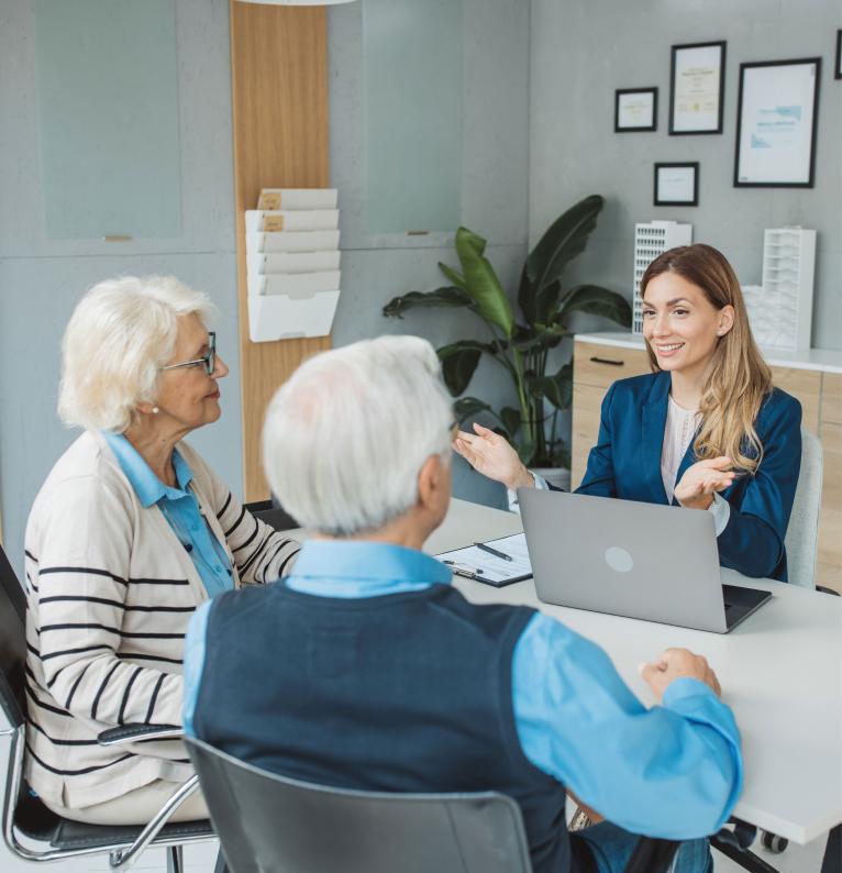 Senior couple consulting with female advisor